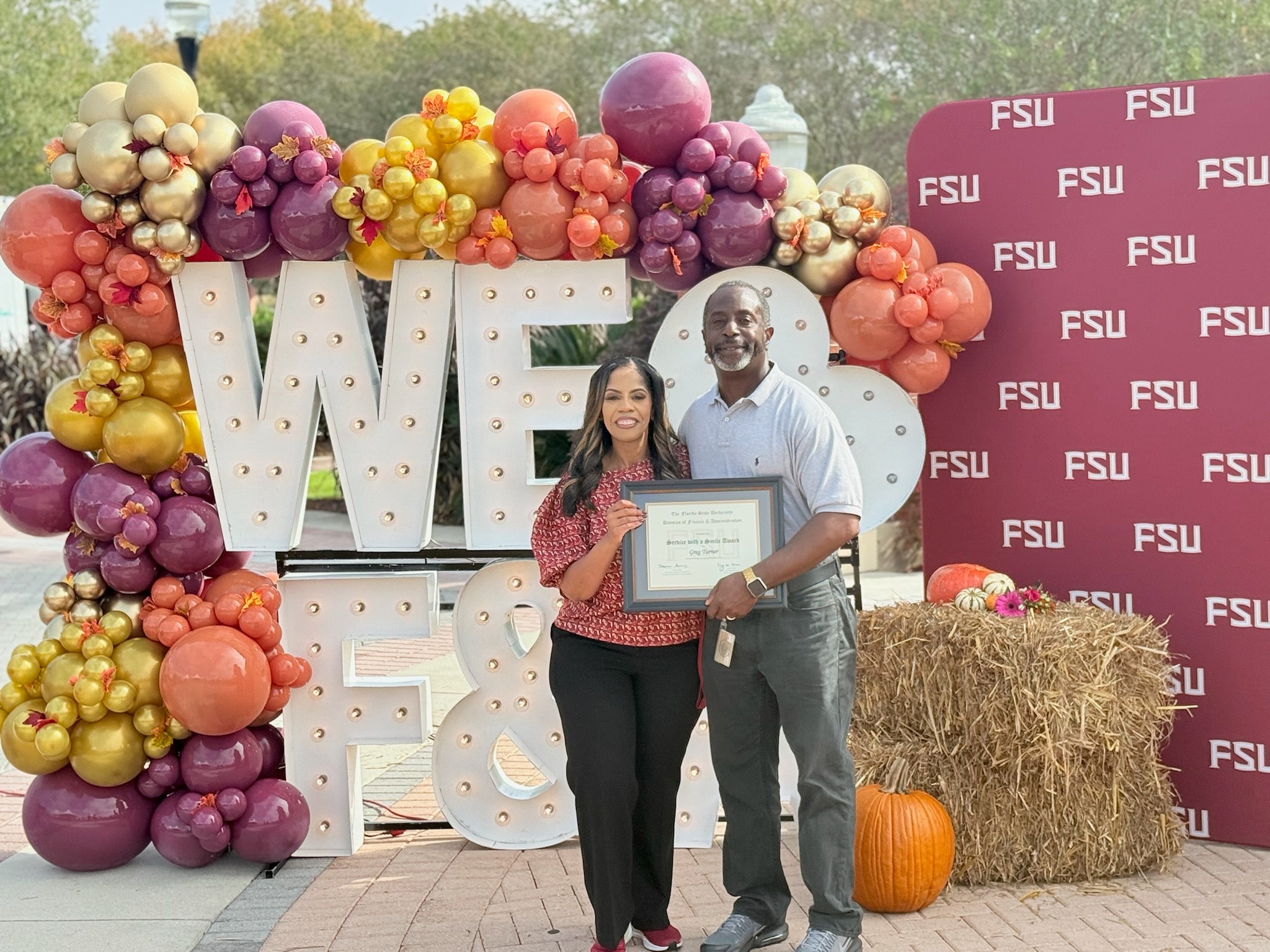 "Image of Renisha Gibbs handing Greg Turner an award at F&A Appreciation event."