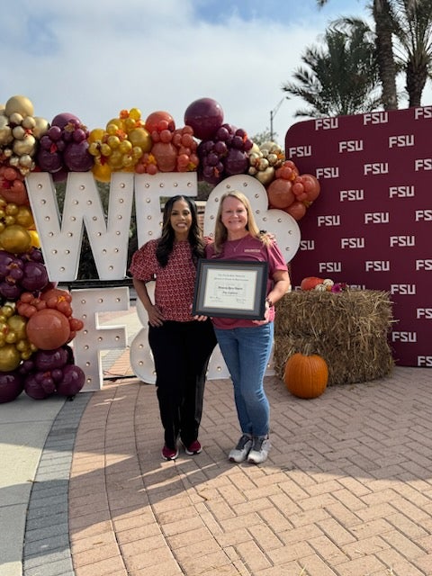 "Image of Amy Espinosa holding an award standing next to Renisha Gibbs at F&A Appreciation Event."
