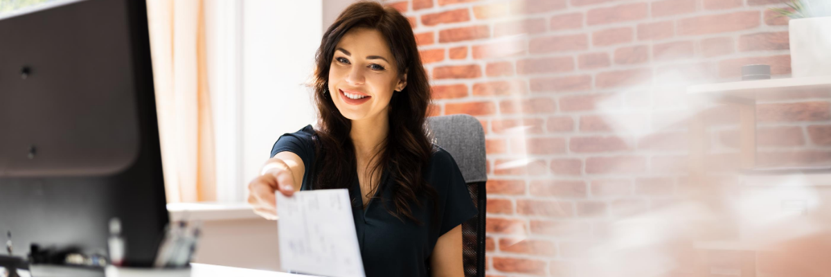 woman holding paycheck