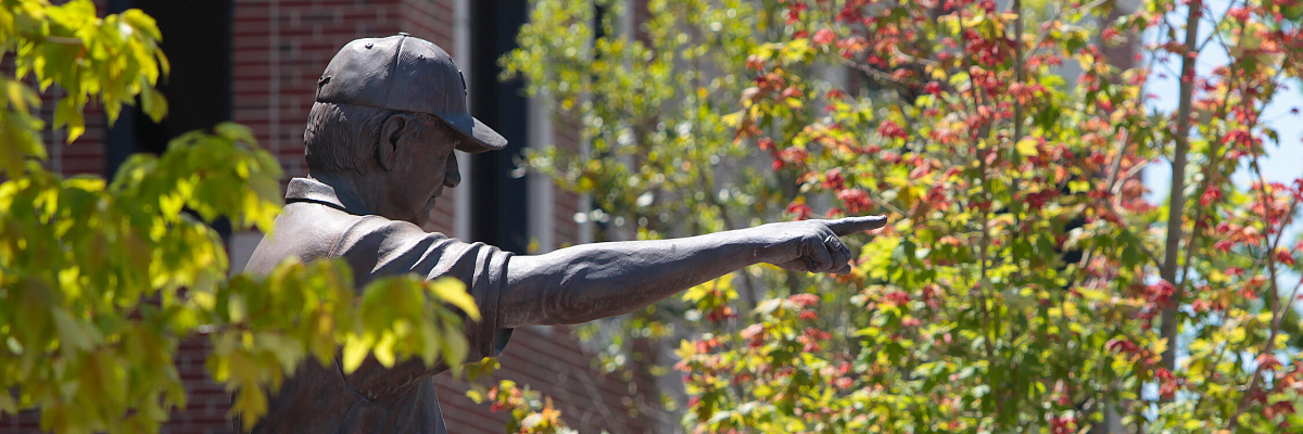 statue pointing forward