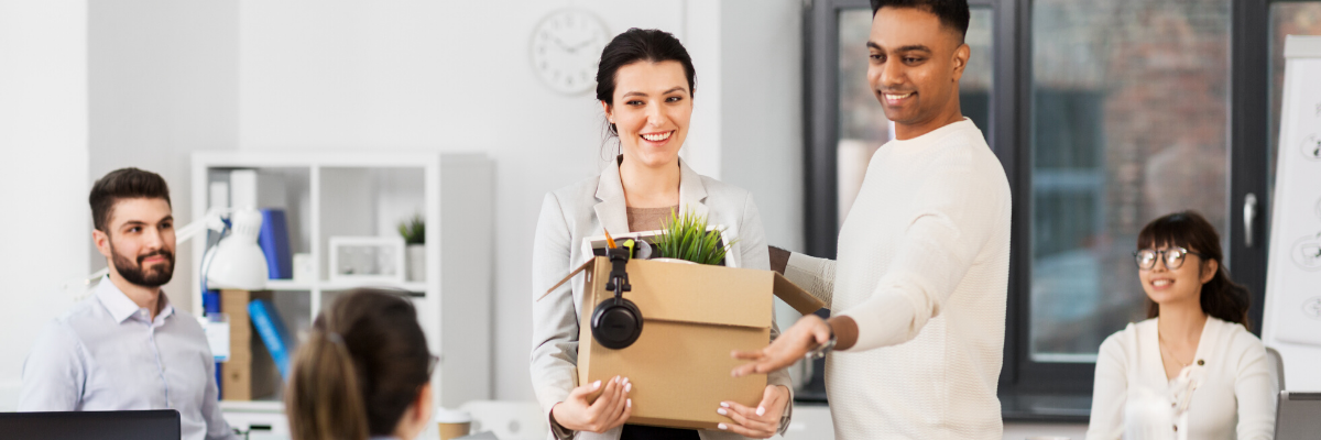 new employee holding box of belongings at new job